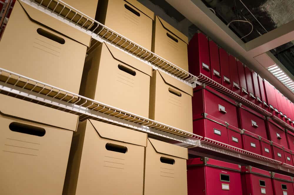 carboard-and-red-boxes-stored-on-shelf