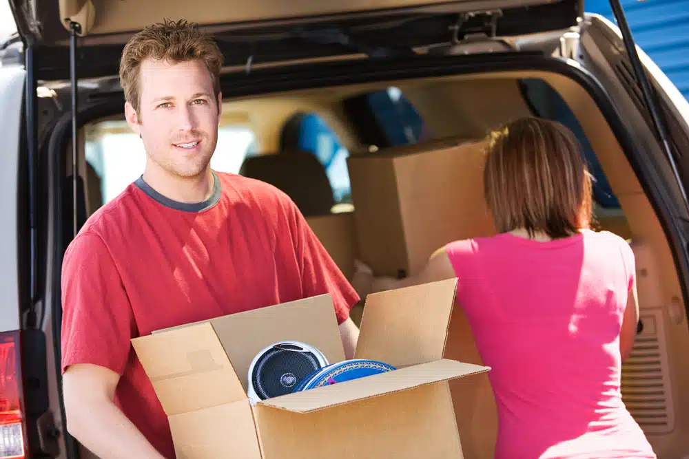 A couple moving boxes