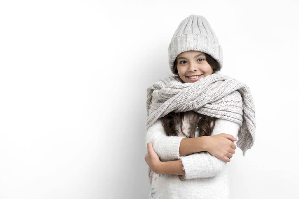 Girl in winter clothes before storing them in self storage