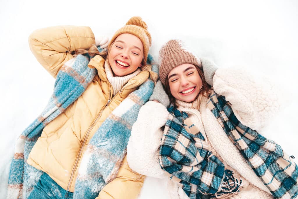 Two young girls with winter clothes before storing them in self storage