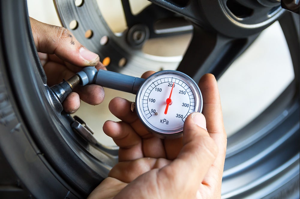 checking motorcycle tire pressure in storage unit