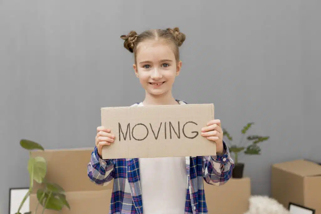 Little girl carrying box