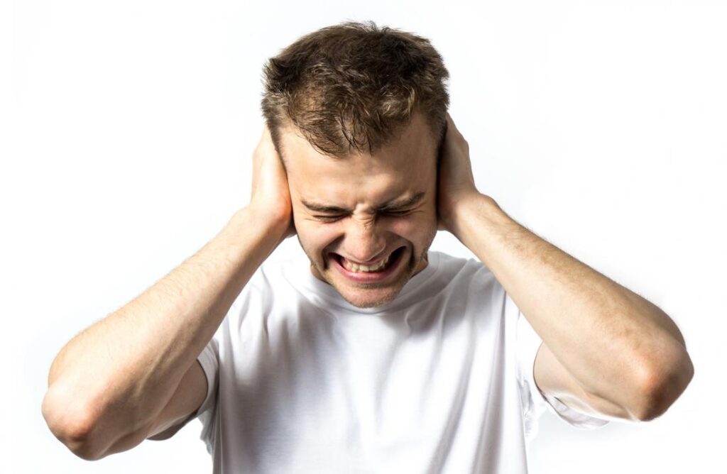 young man protecting ears