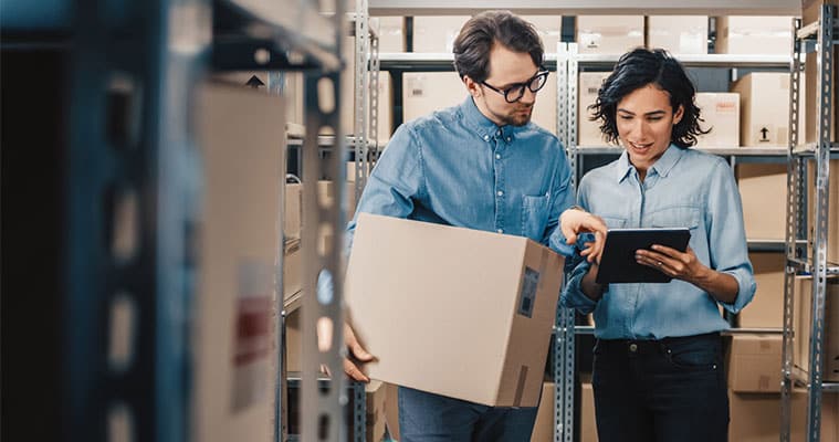 man and woman managing inventory in storage unit