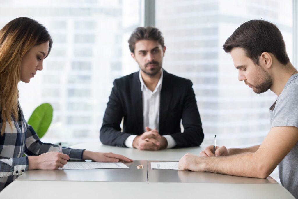 Couple signing divorce agreement